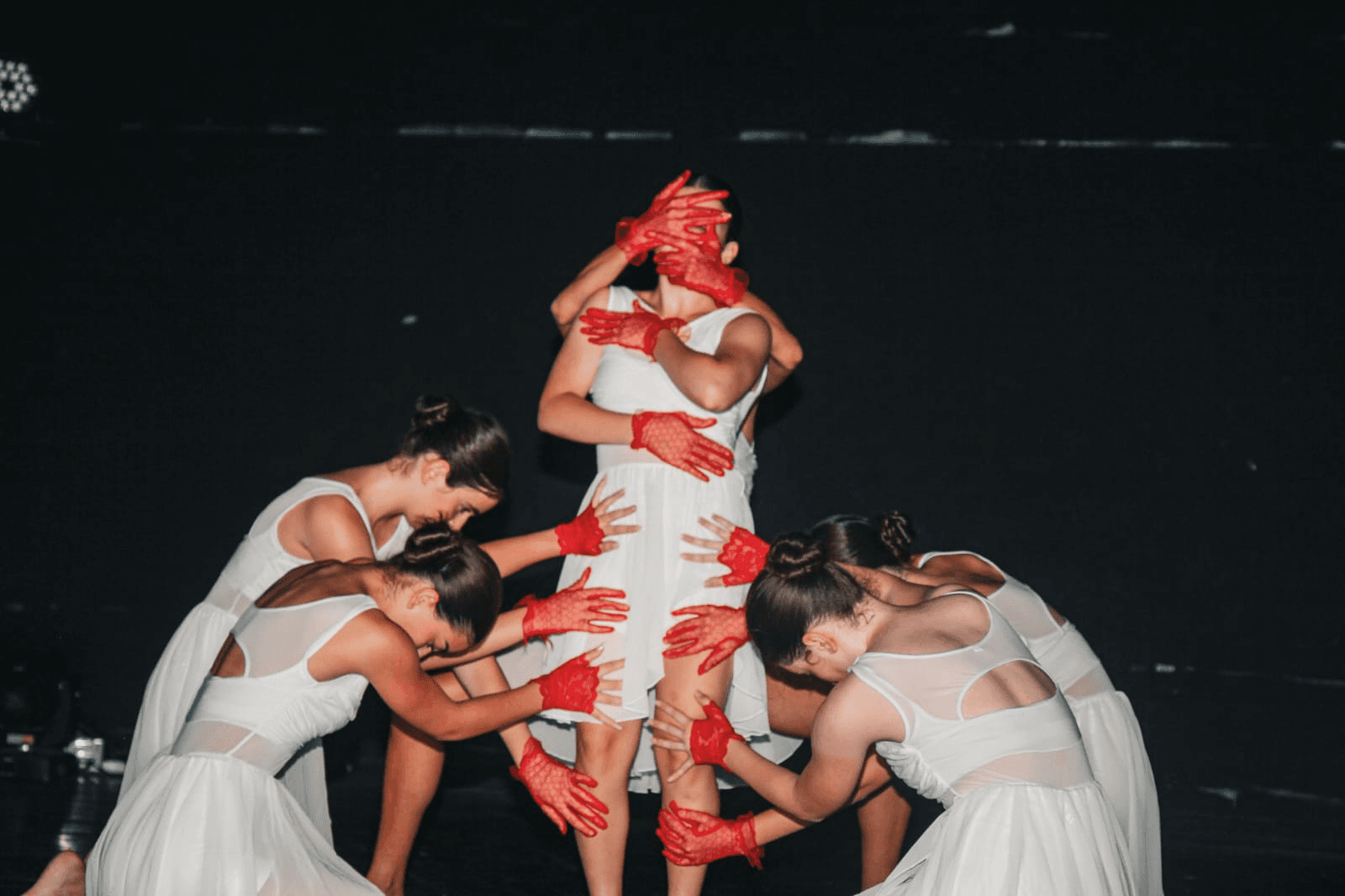 Artistic performance with red gloves and white dresses